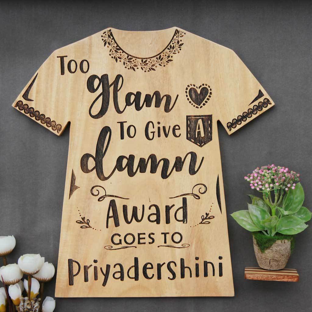 Too Glam To Give A Damn Wooden Award Plaque In The Shape Of a T-shirt. This Personalized Wooden Plaque Makes The Best Gift For Fashionistas. Looking For Friendship day gifts, gifts for friends or gifts for sister? This funny award make unique gifts. This Is also A great gift for fashion bloggers.