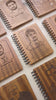 Customised wooden office diaries  engraved with photo sketches of team members and a personalised message for a customised corporate gift set  