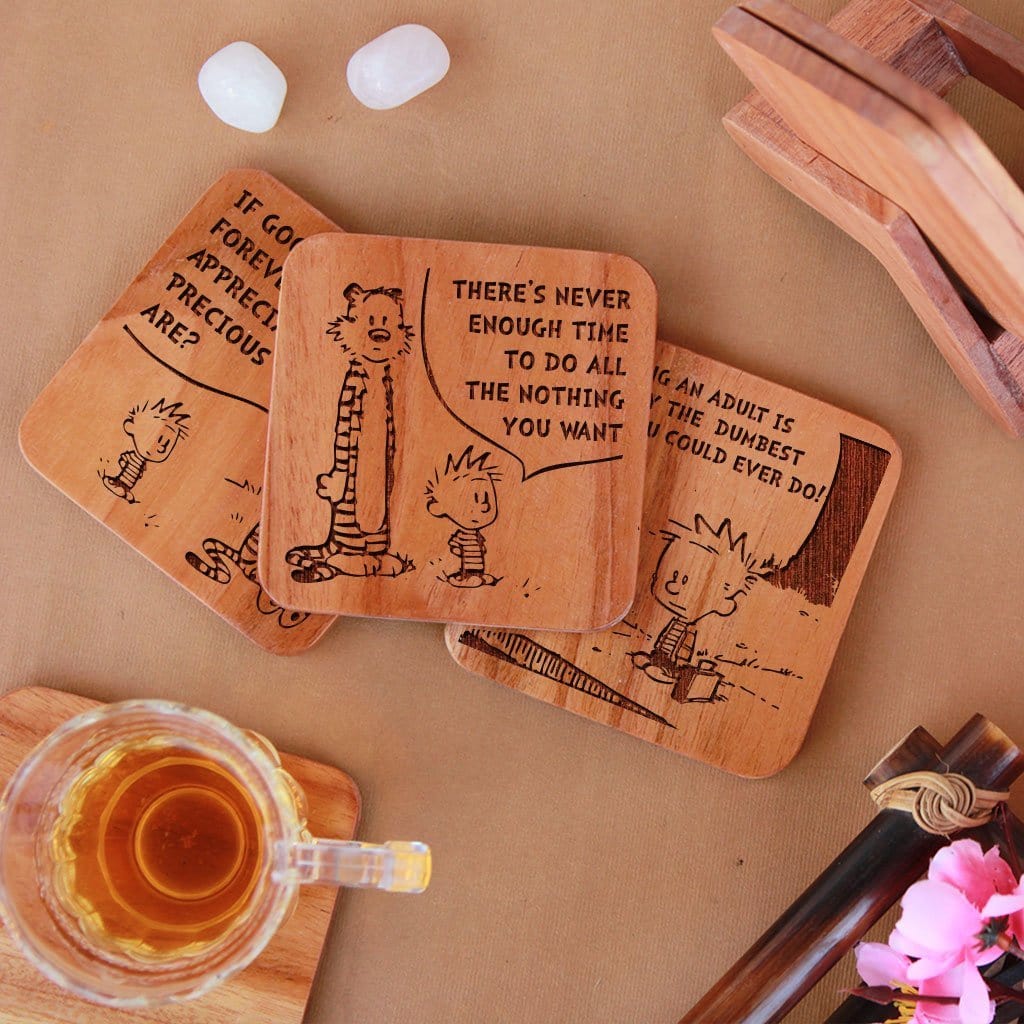 Calvin and Hobbes - Wooden Coaster Set With Holder. Gift coasters engraved with Calvin and Hobbes quotes. This coaster set is the best engraved wooden coasters and funky coaster which can be used as tea coaster and coffee coaster. This square coaster and natural wood coaster is one of the best gifts for Calvin and Hobbes fans.
