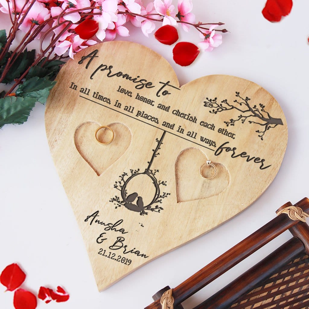 A Wooden Heart Shaped Ring Holder Engraved With Wedding Vow: A promise to love, honor, and cherish each other, in all times, in all places, and in all ways, forever. This Personalised Ring Tray Is Engraved With Couple Names & Wedding Date. This wedding ring holder is one of the best wedding gifts or engagement gifts for couples.