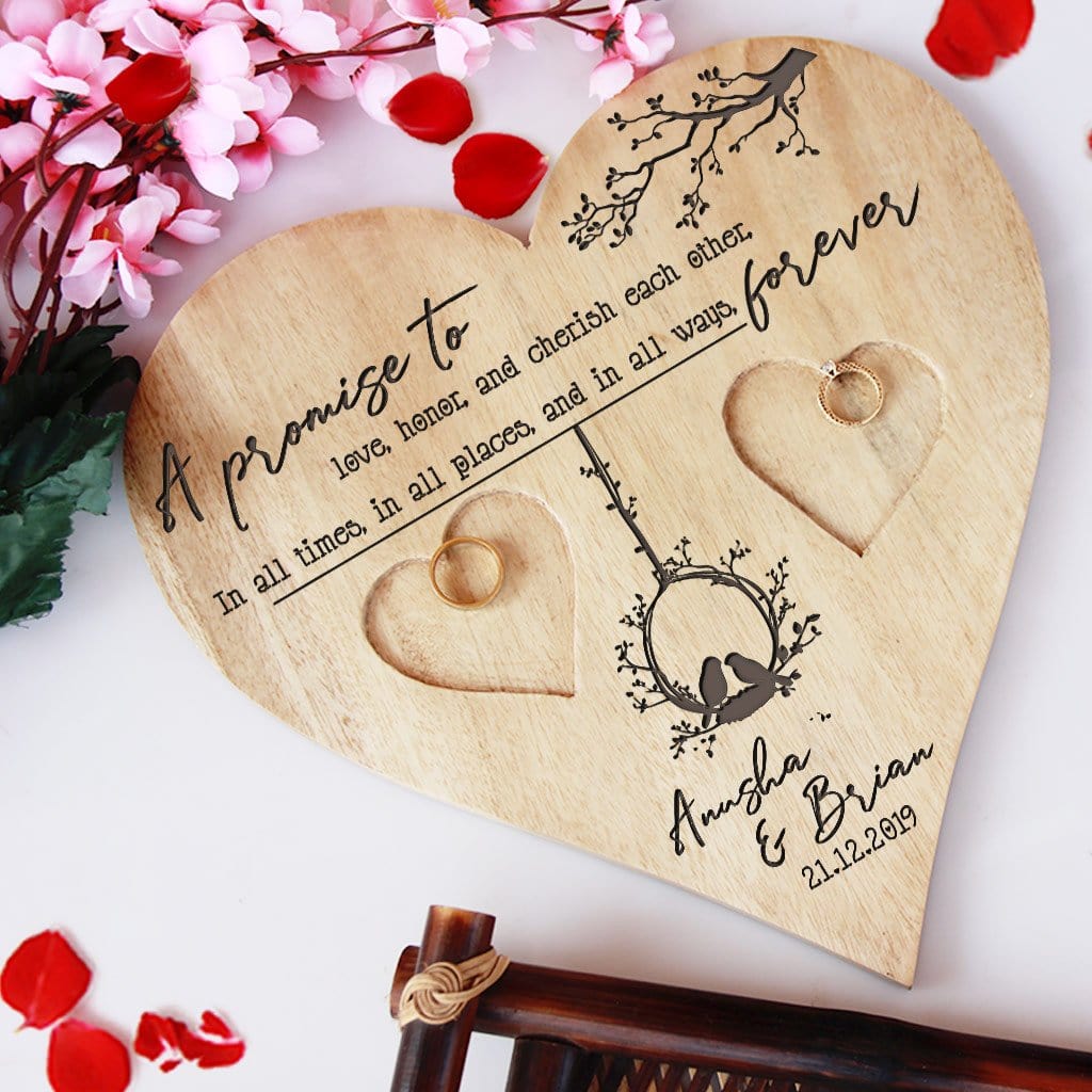 A Wooden Heart Shaped Ring Holder Engraved With Wedding Vow: A promise to love, honor, and cherish each other, in all times, in all places, and in all ways, forever. This Personalised Ring Tray Is Engraved With Couple Names & Wedding Date. This wedding ring holder is one of the best wedding gifts or engagement gifts for couples.