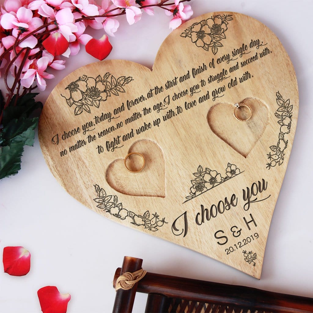 A Wooden Heart Ring Holder Engraved With A Love Quote: I choose you, today and forever, at the start and finish of every single day, no matter the season, no matter the age, I choose you to struggle and succeed with, to fight and wake up with, to love and grow old with. I choose you. This Personalised Ring Tray Is Engraved With Initials & Date. This engagement ring tray is one of the best engagement gifts for couples and wedding gifts.