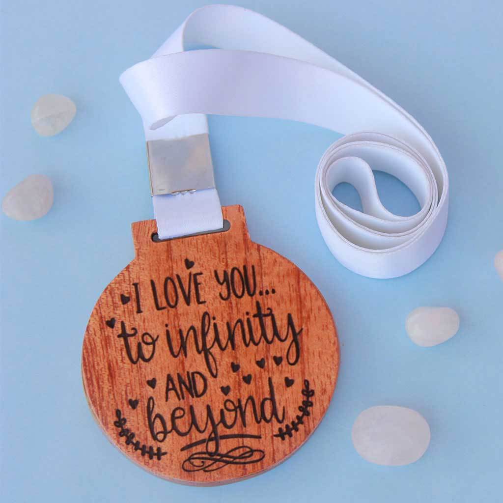 I Love You To Infinity and Beyond Wooden Medal. This Custom Medal Is One Of The Most Romantic Gifts For Girlfriend or Boyfriend. These Trophy Medals And Trophies Also Make Amazing Valentine&#39;s Day Gifts.