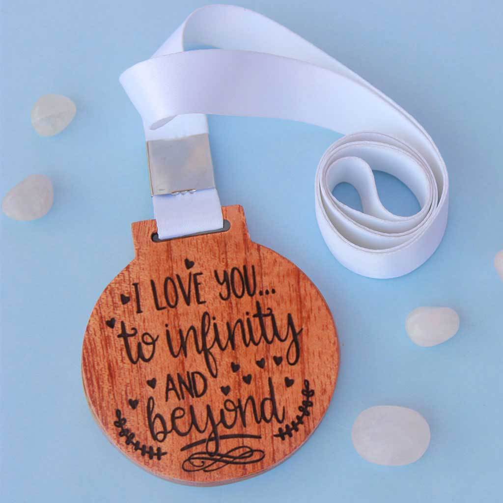 I Love You To Infinity and Beyond Wooden Medal. This Custom Medal Is One Of The Most Romantic Gifts For Girlfriend or Boyfriend. These Trophy Medals And Trophies Also Make Amazing Valentine's Day Gifts.