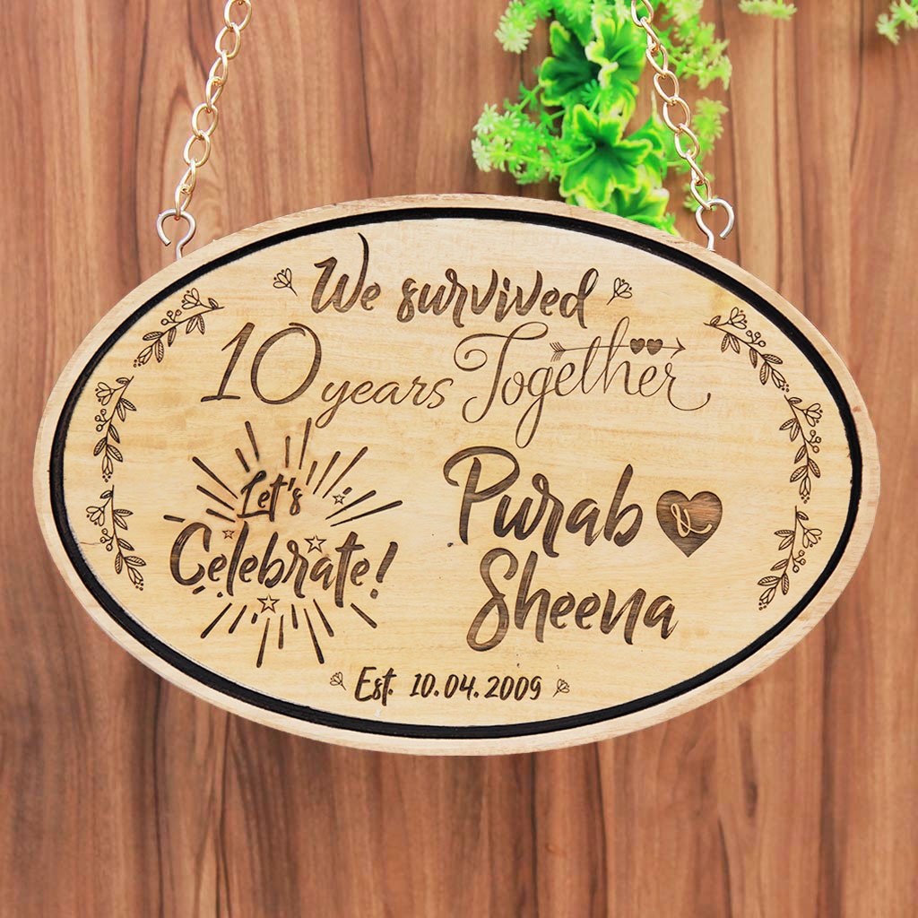 We Survived Funny Anniversary Wishes Engraved On Hanging Wooden Sign. This wood engraved photo is makes great photo gifts. This Personalized Wooden Plaque Is A Funny Anniversary Gift For Him And Her - These Hanging Name Signs Also Make Great Party Accessories For Anniversary Parties.