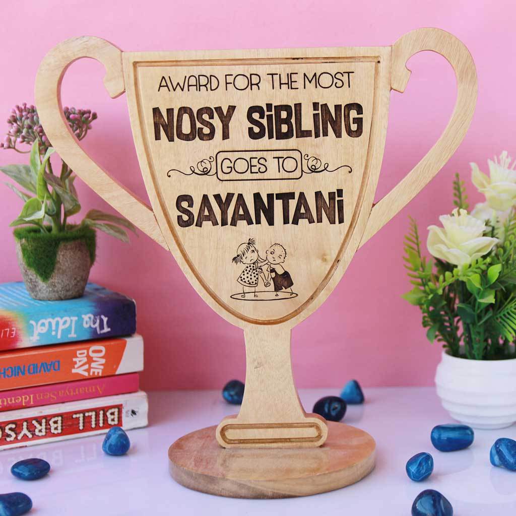 Most Nosy Sibling Wooden Trophy Cup. This funny award is one of the best gifts for sister and gifts for brother. Custom trophies can be personalized with your sibling&#39;s name.
