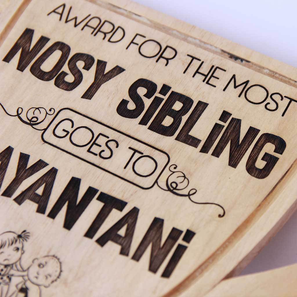 Most Nosy Sibling Wooden Trophy Cup. This funny award is one of the best gifts for sister and gifts for brother. Custom trophies can be personalized with your sibling's name.