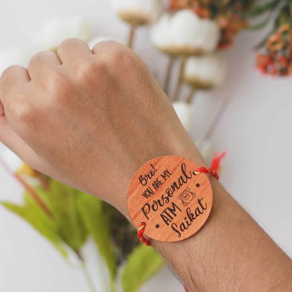 Bro You&#39;re My Personal ATM Wooden Rakhi &amp; Greeting Card. This Personalised Rakhi can be customised with a name. The wooden Rakhi card can be engraved with Raksha Bandhan greetings. Buy Rakhi Online &amp; Send Rakhi Online with Woodgeek Store
