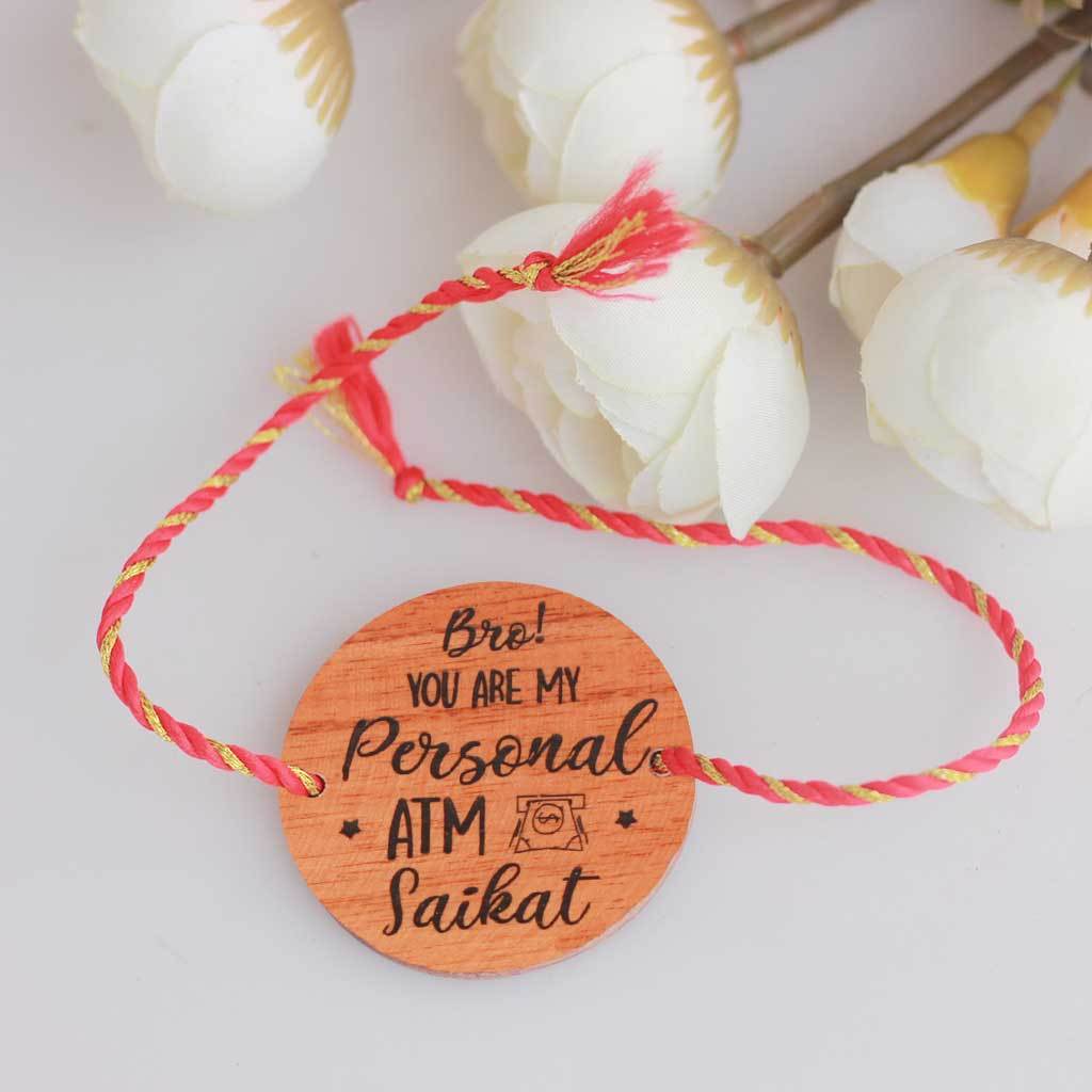 Bro You&#39;re My Personal ATM Wooden Rakhi &amp; Greeting Card. This Personalised Rakhi can be customised with a name. The wooden Rakhi card can be engraved with Raksha Bandhan greetings. Buy Rakhi Online &amp; Send Rakhi Online with Woodgeek Store
