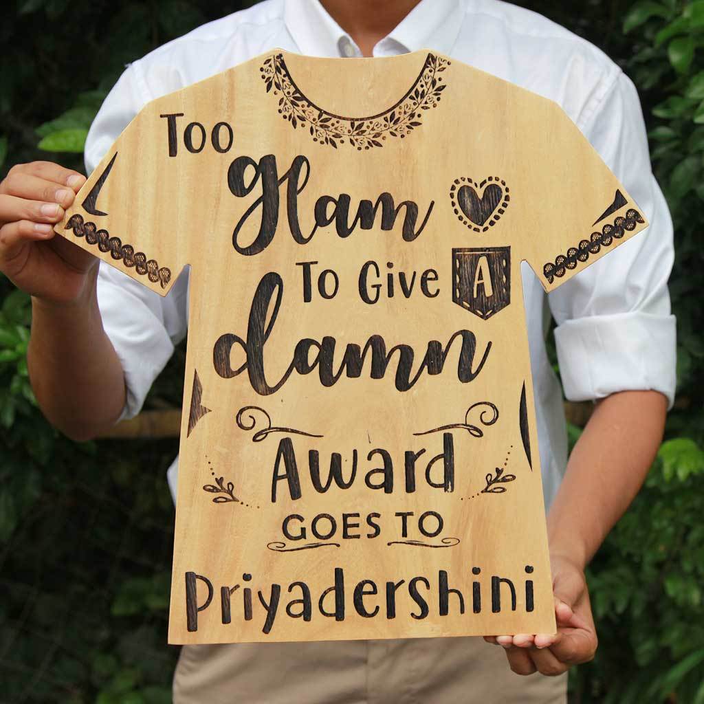 Too Glam To Give A Damn Wooden Award Plaque In The Shape Of a T-shirt. This Personalized Wooden Plaque Makes The Best Gift For Fashionistas. Looking For Friendship day gifts, gifts for friends or gifts for sister? This funny award make unique gifts. This Is also A great gift for fashion bloggers.