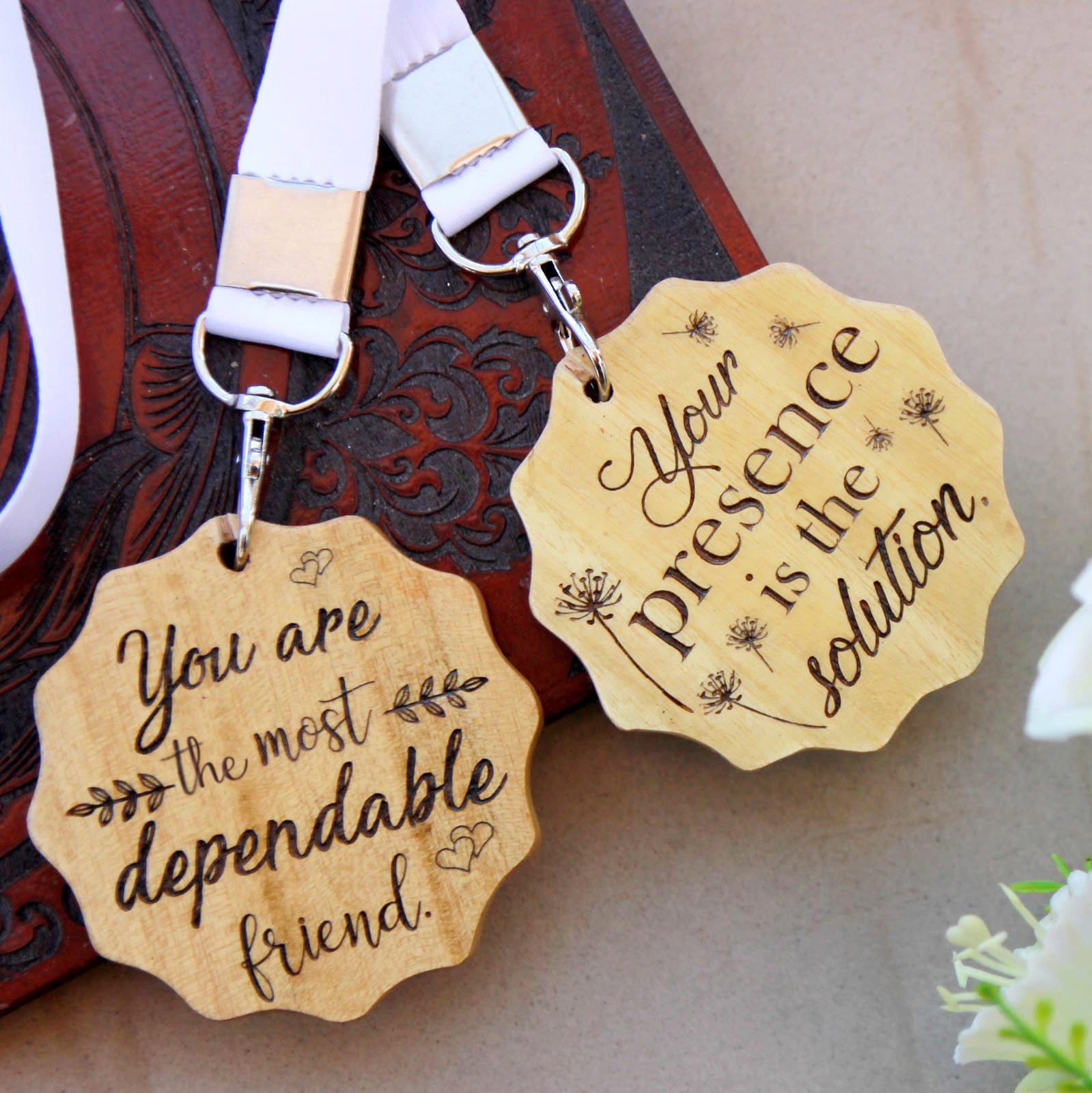 A Set Of 2 Wooden Medal For Friends Engraved With The Words: You are the most dependable friend & Your presence is the solution. These medals make affordable gifts for friends and the best personalised gifts for friends.