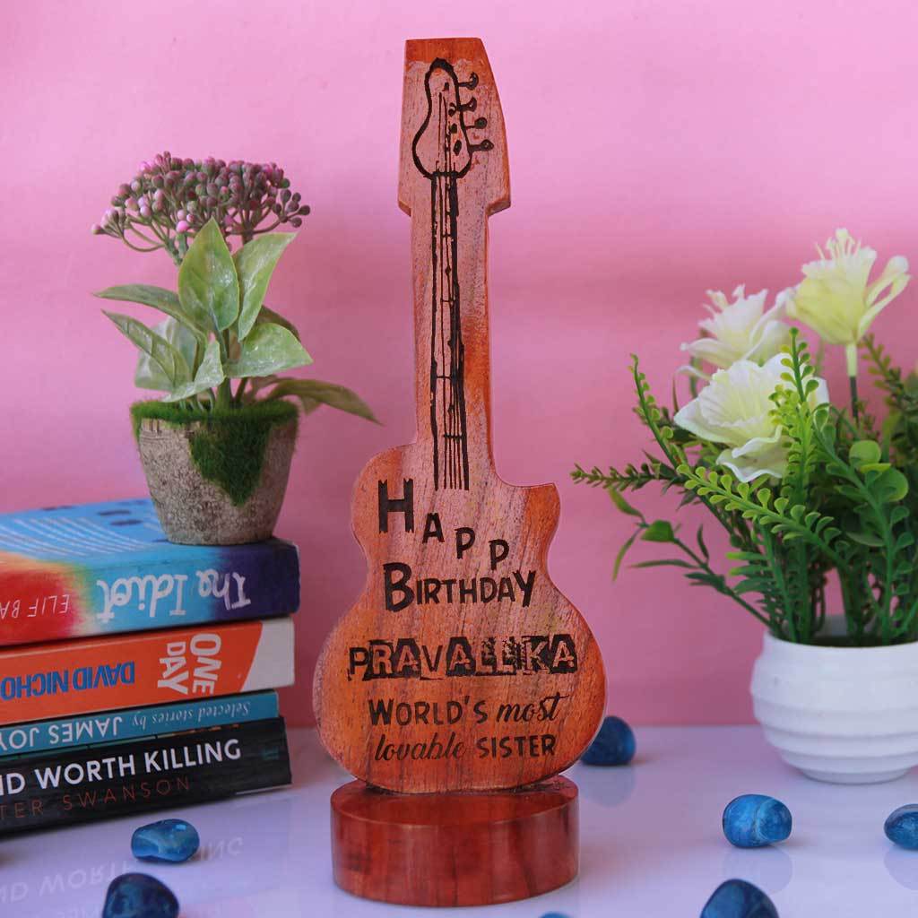 Happy Birthday To The World's Most Lovable Sister Custom Wooden Plaque.  This Personalized Plaque Comes In The Shape Of A Guitar. This Wooden Stand makes Unique Gifts For Sisters. Shop More Personalized Birthday Gifts For Sisters Online From The Woodgeek Store.