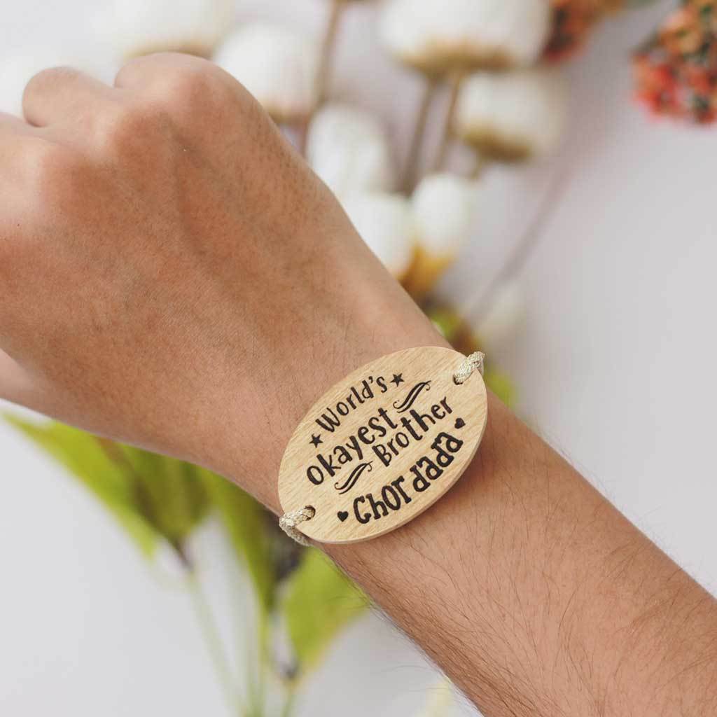 World's Okayest Brother Personalised Rakhi With Name. This Wooden Rakhi Is The Best Raksha Bandhan Gifts for Brother. Buy Rakhi Online India And Wish Your Brother a Happy Rakhi With Personalized Gifts From The Woodgeek Store.