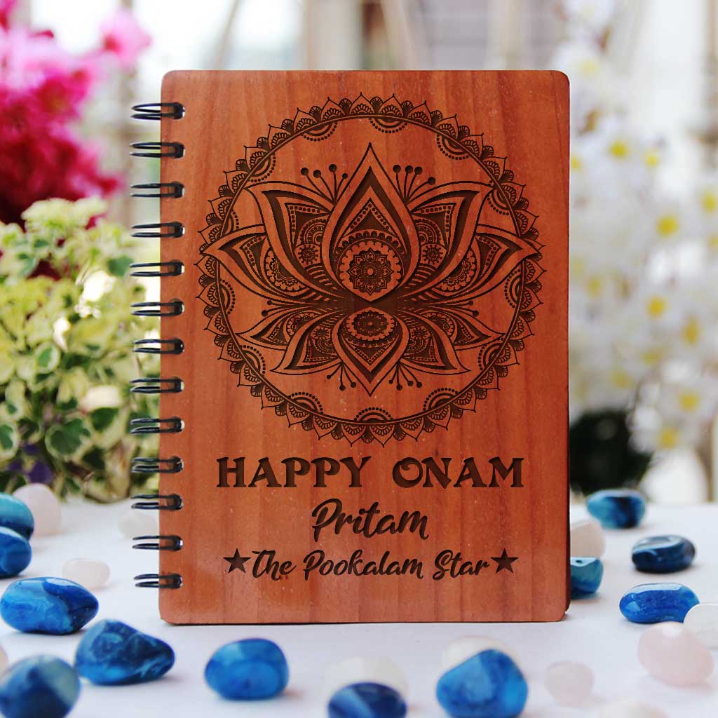 Happy Onam Wooden Notebook Engraved With Pookalam. This Spiral Notebook Makes The Best Onam Gifts. This Personalised Gift Can be engraved with onam wishes in malayalam.