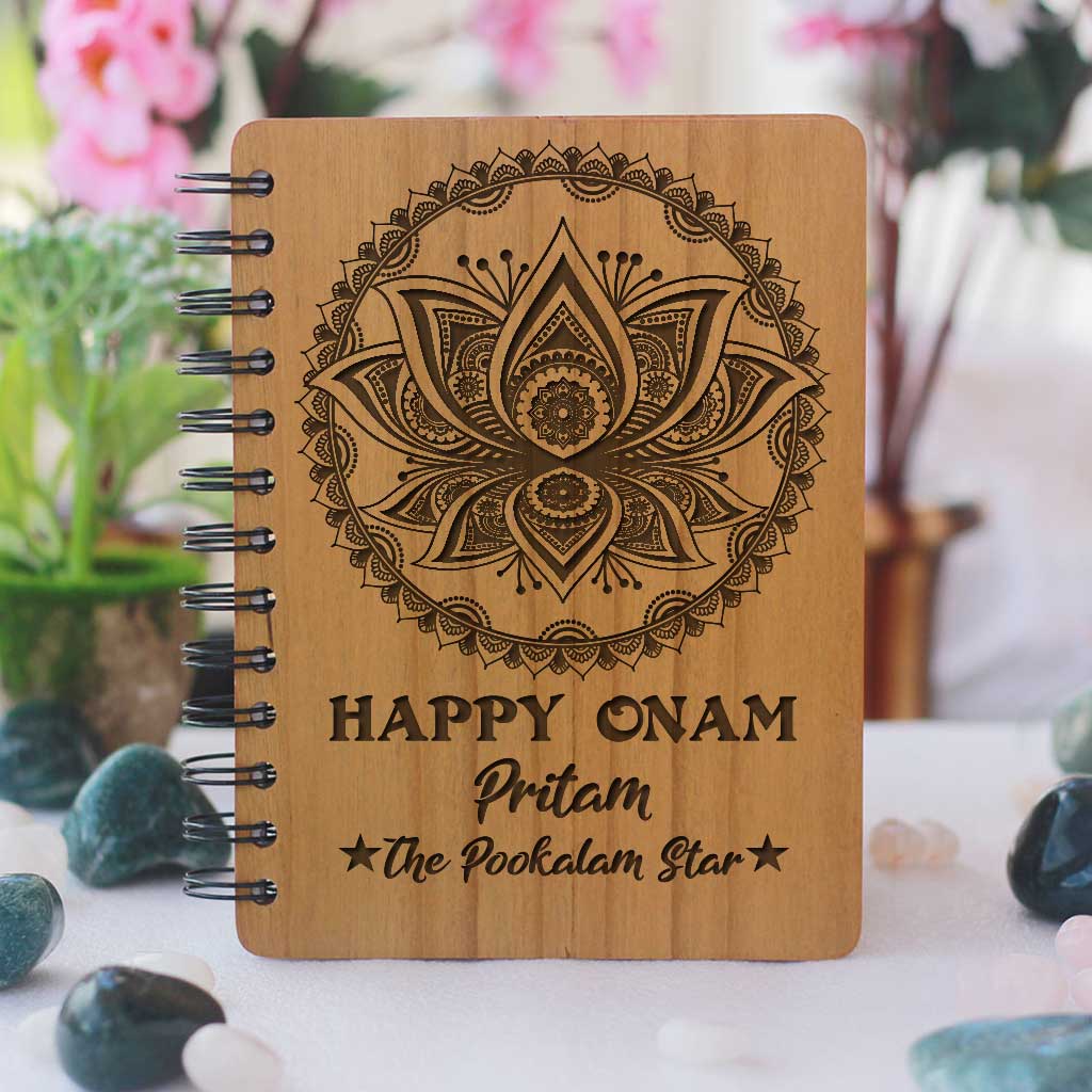 Happy Onam Wooden Notebook Engraved With Pookalam. This Spiral Notebook Makes The Best Onam Gifts. This Personalised Gift Can be engraved with onam wishes in malayalam.
